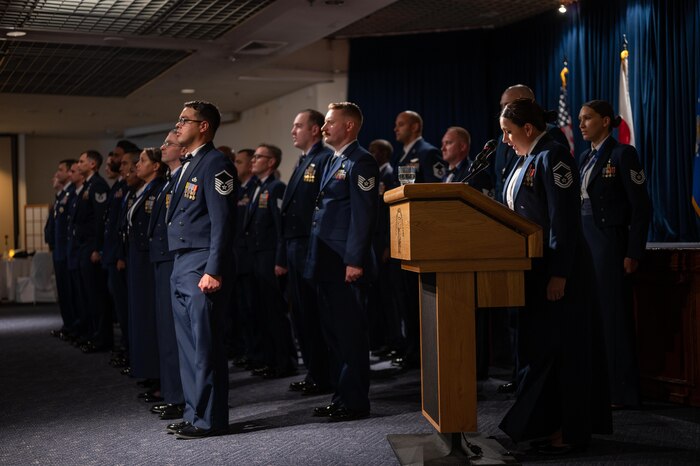 Current and soon-to-be Senior NCO’s stand at attention while reciting the SNCO creed during a SNCO Induction Ceremony.