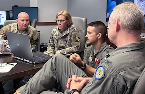 People looking at a laptop