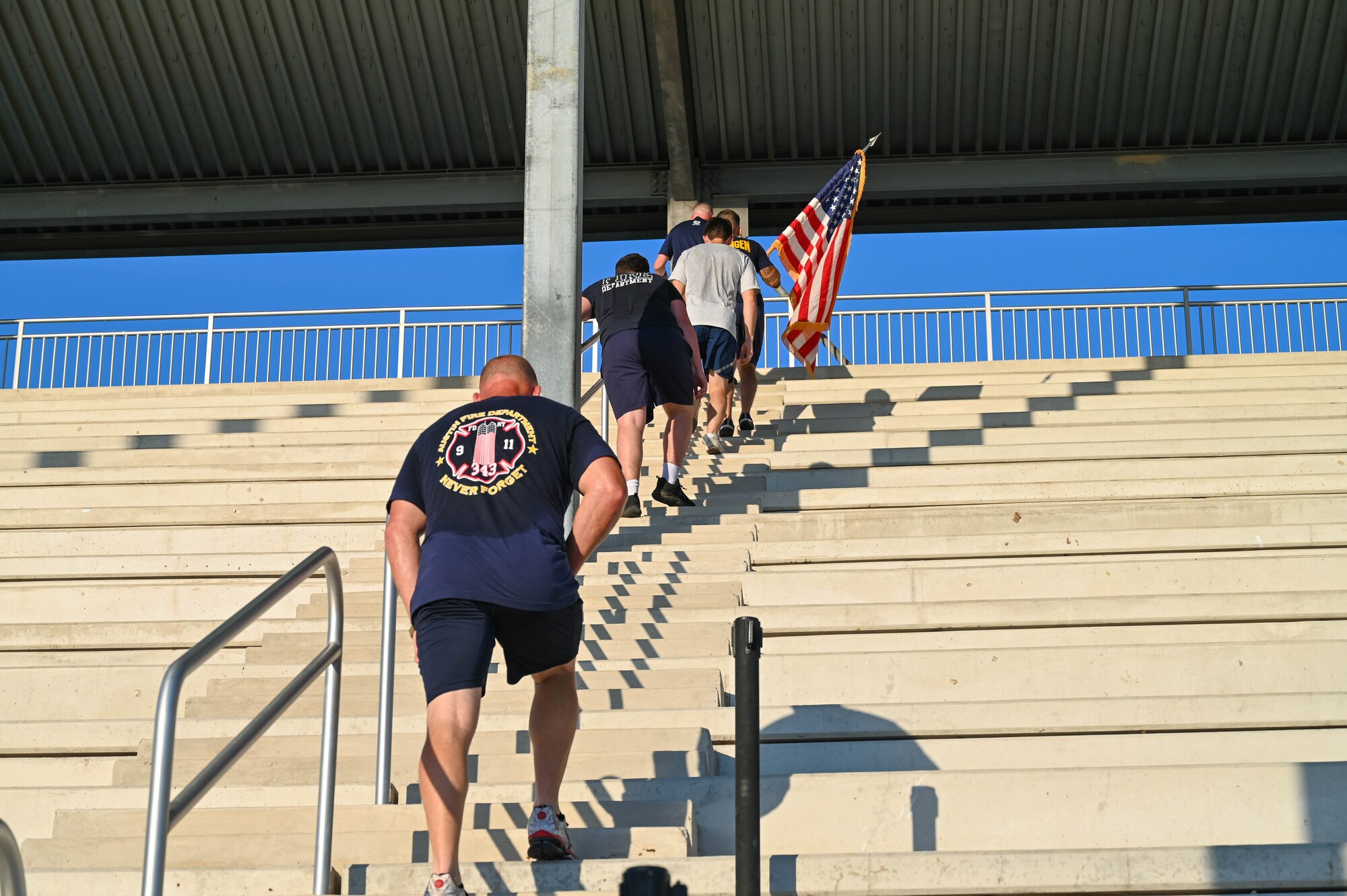 Members of the 433rd Civil Engineer Squadron climb the stairs outside the Pfingston Reception Center on Joint Base San Antonio-Lackland, Texas on Sep. 10, 2023 as part of an annual 9/11 Memorial Stair Climb.