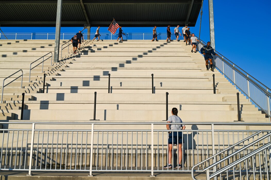 Maj. Rachel Rupp, 433rd Civil Engineer Squadron Operations Flight Commander, cheers on other Airmen after completing the unit’s annual 9/11 Memorial Stair Climb outside the Pfingston Reception Center on Joint Base San Antonio-Lackland, Texas on Sep. 10, 2023.