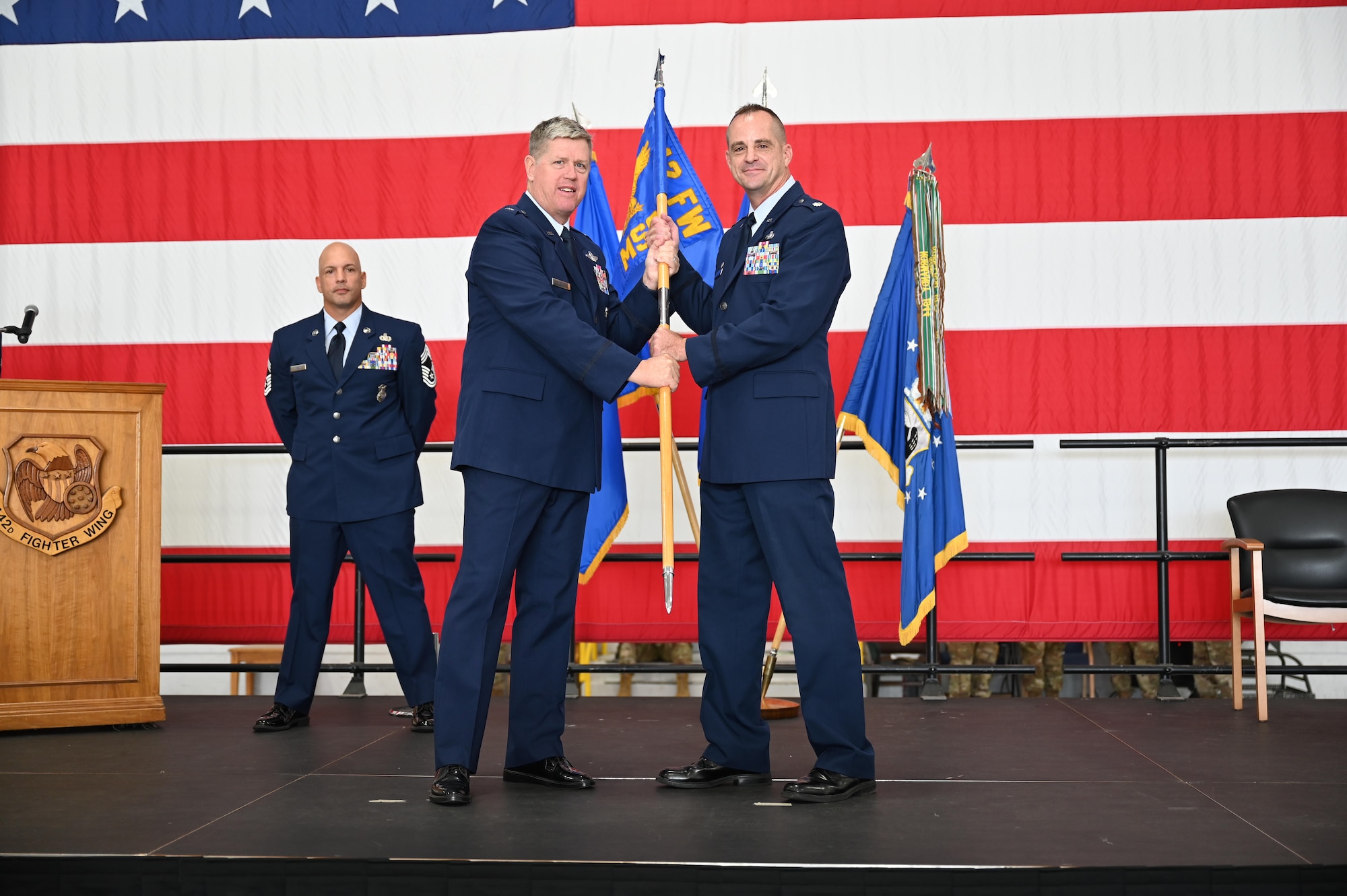 Brig. Gen. Steve Nester passes a flag to Lt. Col. Keith Yersak.