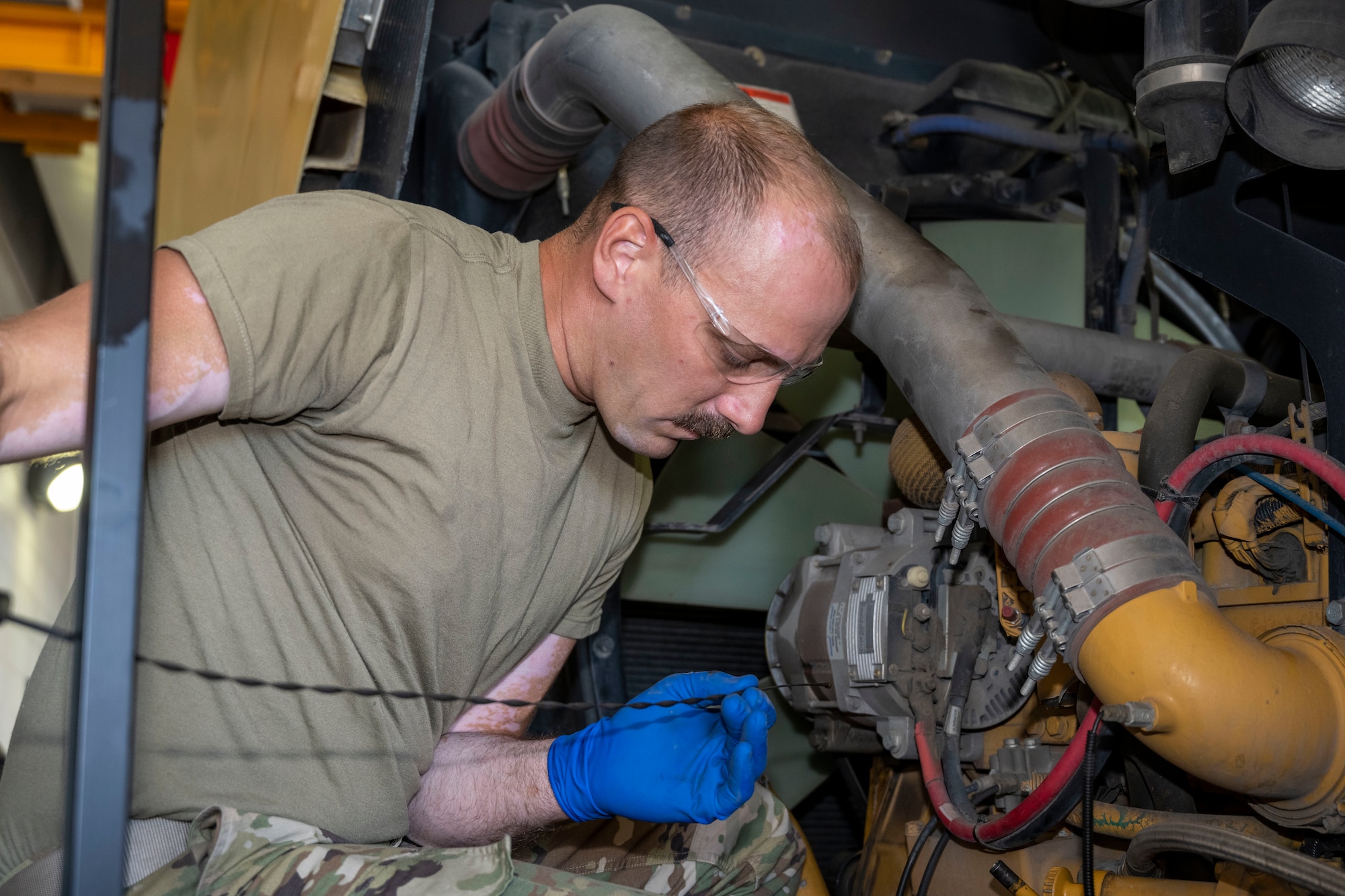 U.S. Air Force Tech. Sgt Eric McFadden, Special Purpose Shop Floor Lead, Vehicle Maintenance, 140th Logistics Readiness Squadron, Colorado Air National Guard, performs a "summer rebuild" as part of scheduled maintenance on 140th Wing snow equipment.