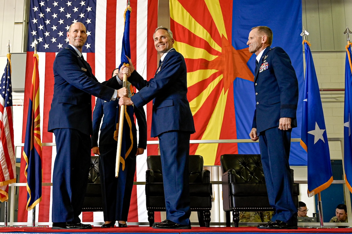U.S. Air Force Col. Brant Putnam takes command of the 162nd Wing while taking the unit guidon passed from Maj. Gen. Troy Daniels the Assistant Adjutant General for the Air, and Air Component Commander, for the Arizona Air National Guard, and serves as the Air National Guard Assistant to the Secretary of the Air Force, International Affairs during a ceremony at Morris Air National Guard Base, Sept. 10. Putnam replaces Butler who retired after more than 35 years of service. (U.S. Air Force photo by Staff Sgt. Van Whatcott)