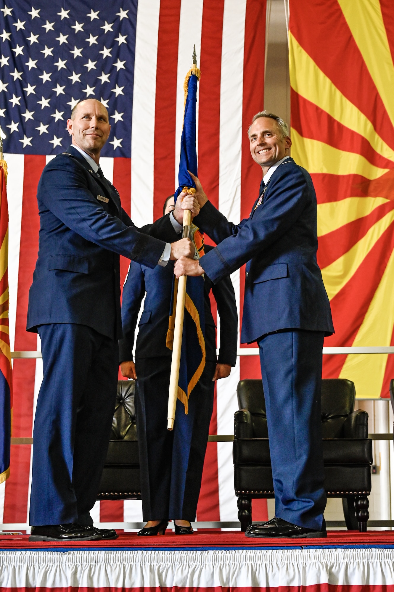 U.S. Air Force Col. Brant Putnam takes command of the 162nd Wing while taking the unit guidon passed from Maj. Gen. Troy Daniels the Assistant Adjutant General for the Air, and Air Component Commander, for the Arizona Air National Guard, and serves as the Air National Guard Assistant to the Secretary of the Air Force, International Affairs during a ceremony at Morris Air National Guard Base, Sept. 10. Putnam replaces Butler who retired after more than 35 years of service. (U.S. Air Force photo by Staff Sgt. Van Whatcott)