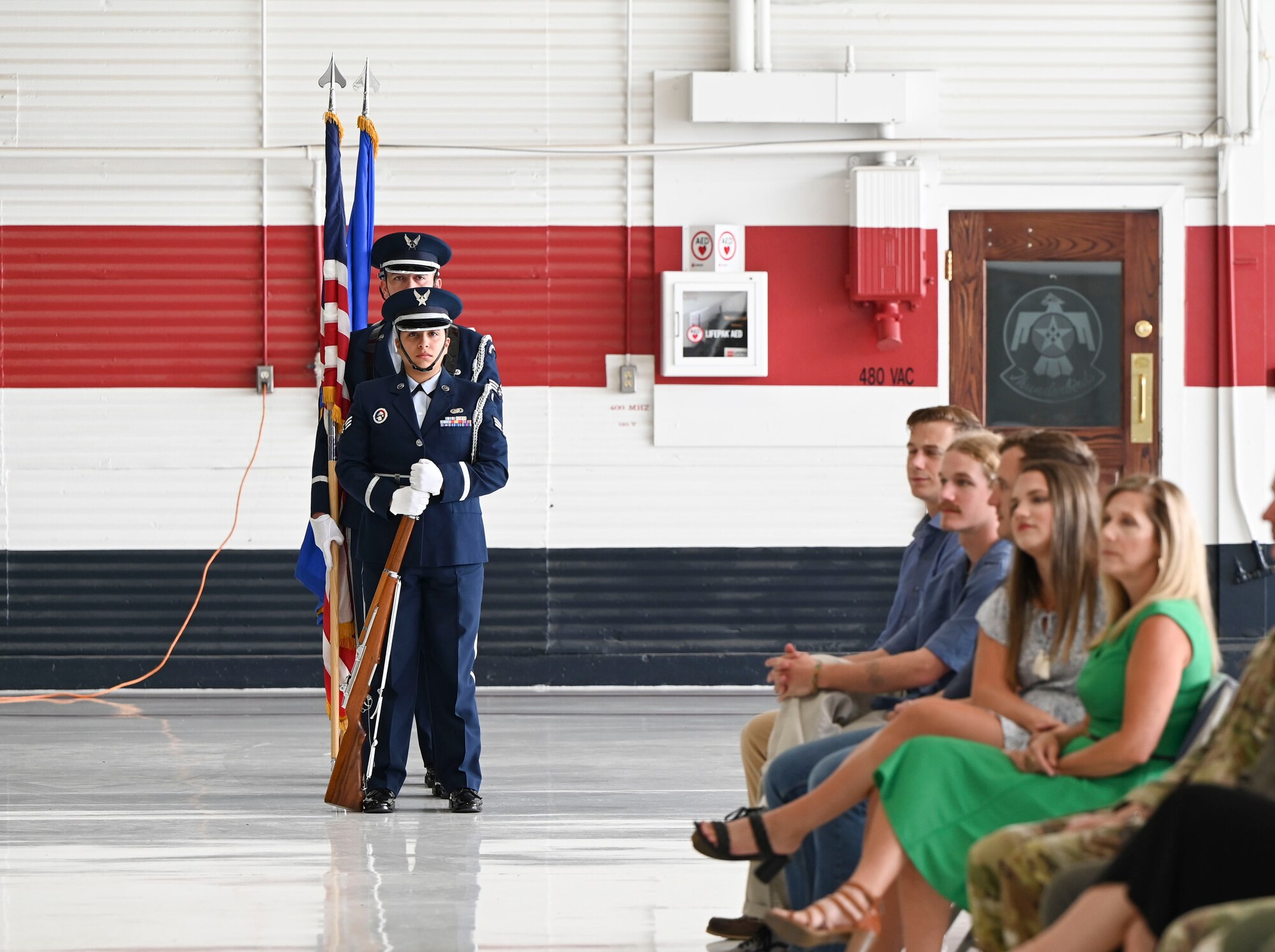 Honor Guard Airmen dressed in their ceremonial uniform wait to post the colors before a ceremony