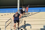 Members of the 433rd Civil Engineering Squadron climb the stairs outside the Pfingston Reception Center on Joint Base San Antonio-Lackland, Texas on Sep. 10, 2023 as part of an annual 9/11 Memorial Stair Climb.