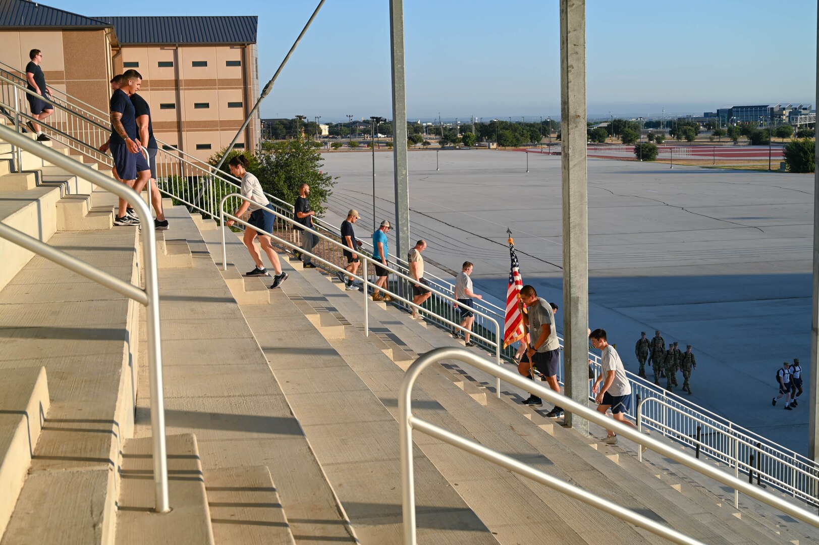 Members of the 433rd Civil Engineering Squadron climb the stairs outside the Pfingston Reception Center on Joint Base San Antonio-Lackland, Texas on Sep. 10, 2023 as part of an annual 9/11 Memorial Stair Climb.