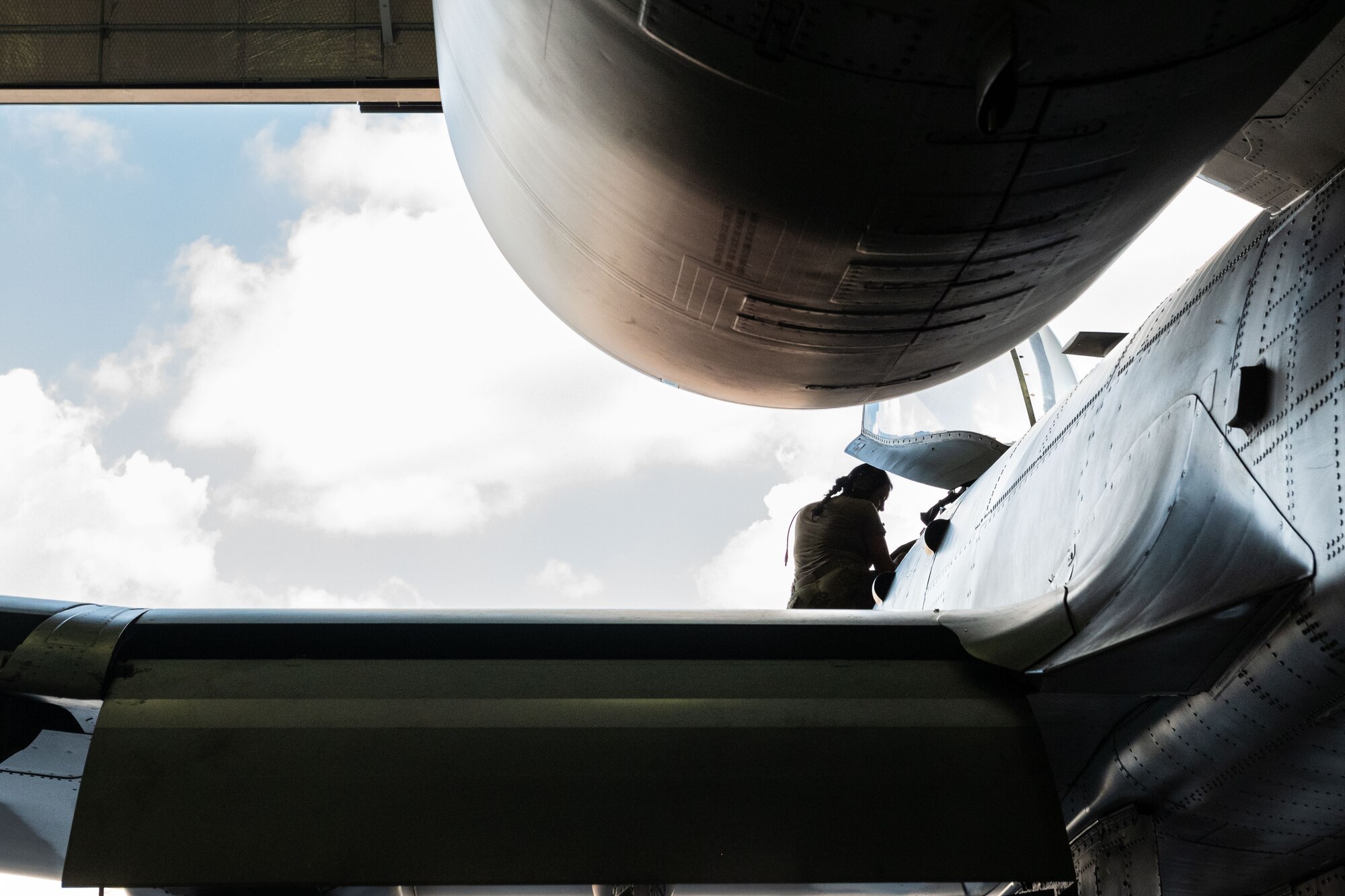 A photo of an Airman climbing into the cockpit of an A-10C Thunderbolt II