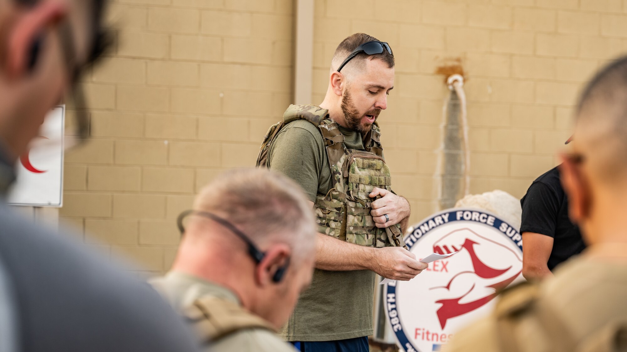 U.S. Air Force Chaplain David Sidnam, 386th Air Expeditionary Wing, delivers an invocation before a 9/11 memorial ruck march at Ali Al Salem Air Base, Kuwait, Sept. 11, 2023. Service members from the U.S., Canada, Italy, and Denmark gathered together today for a moment of silence followed by a ruck march in remembrance of the innocent lives lost during the attacks on this fateful day 22 years ago. Sharing the past with our coalition partners secures a brighter future for us all. (U.S. Air Force photo by Staff Sgt. Kevin Long)