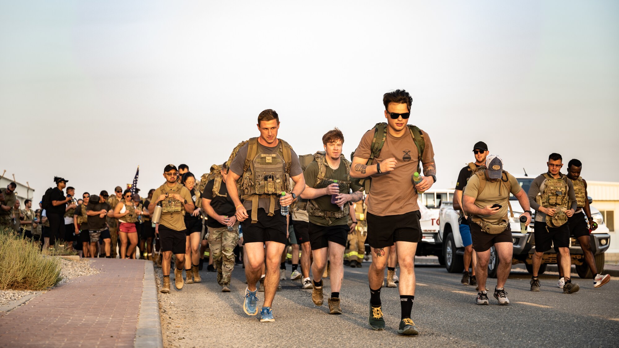 Service members from multiple nations across the base begin the 9/11 memorial ruck at Ali Al Salem Air Base, Kuwait, Sept. 11, 2023. Service members from the U.S., Canada, Italy, and Denmark gathered together today for a moment of silence followed by a ruck march in remembrance of the innocent lives lost during the attacks on this fateful day 22 years ago. Sharing the past with our coalition partners secures a brighter future for us all. (U.S. Air Force photo by Staff Sgt. Kevin Long)