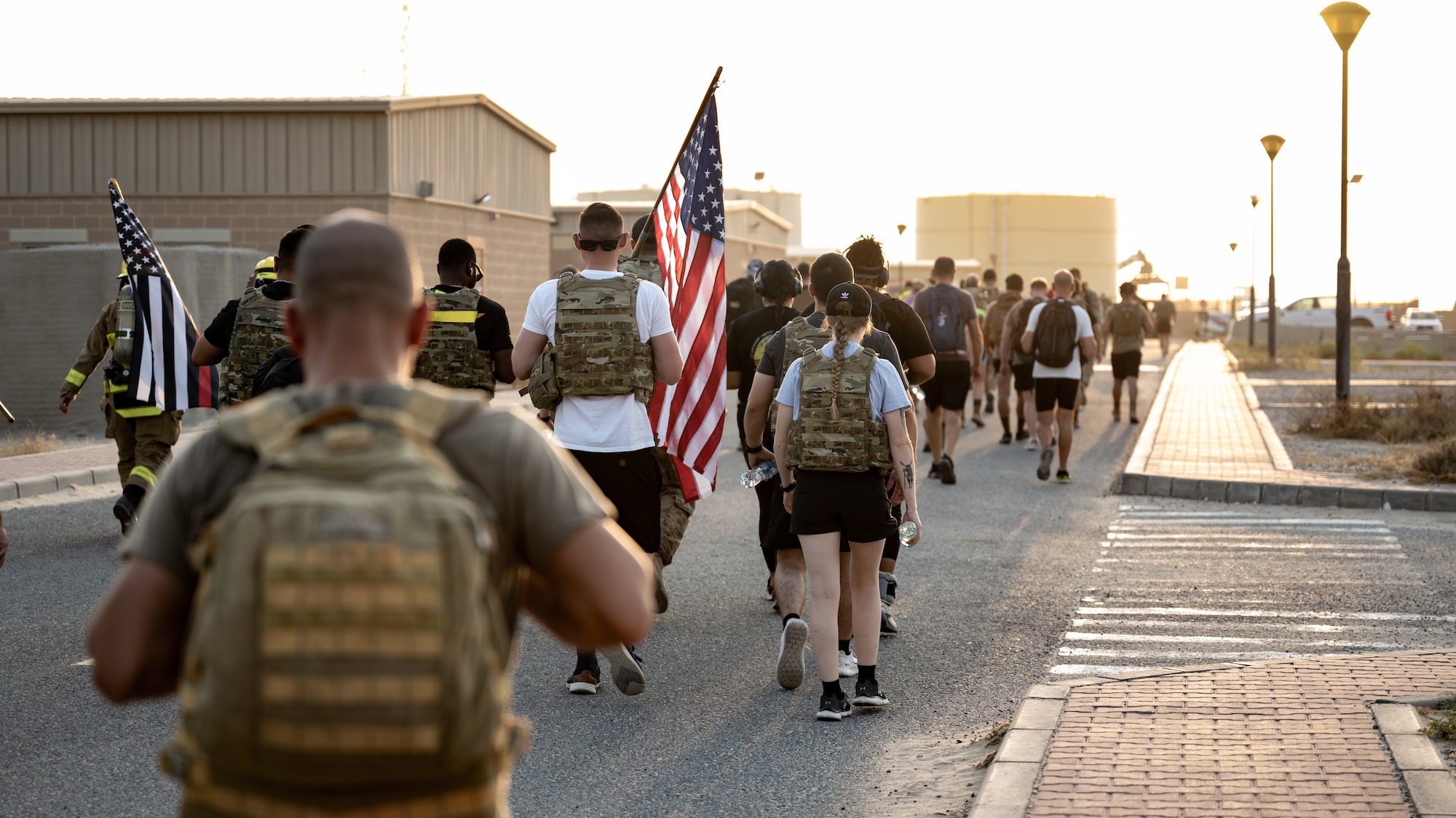 Service members from multiple nations across the base begin the 9/11 memorial ruck at Ali Al Salem Air Base, Kuwait, Sept. 11, 2023. Service members from the U.S., Canada, Italy, and Denmark gathered together today for a moment of silence followed by a ruck march in remembrance of the innocent lives lost during the attacks on this fateful day 22 years ago. Sharing the past with our coalition partners secures a brighter future for us all. (U.S. Air Force photo by Staff Sgt. Kevin Long)