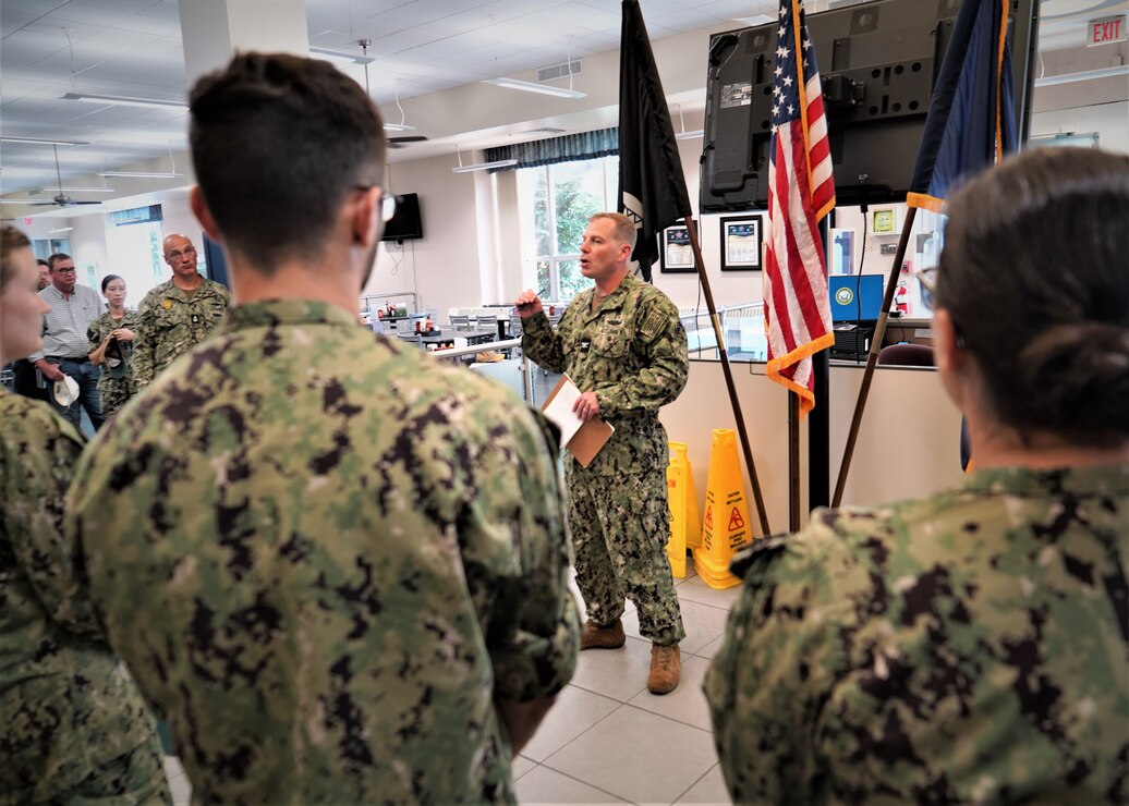 Installation Commanding Officer Capt. Henry Roenke addresses a crowd of military and civilian command members during a quarters held Sept. 7, 2023 in the Ney Hall Galley. This quarters was Roenke's first following his assumption of command on July 28, 2023.