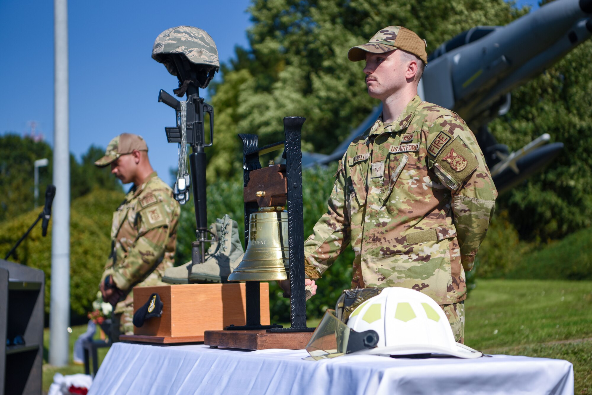 U.S. Air Force Senior Airman Jared Waddell, 52nd Civil Engineers Squadron firefighter, rings a bell during a 9/11 Remembrance ceremony
