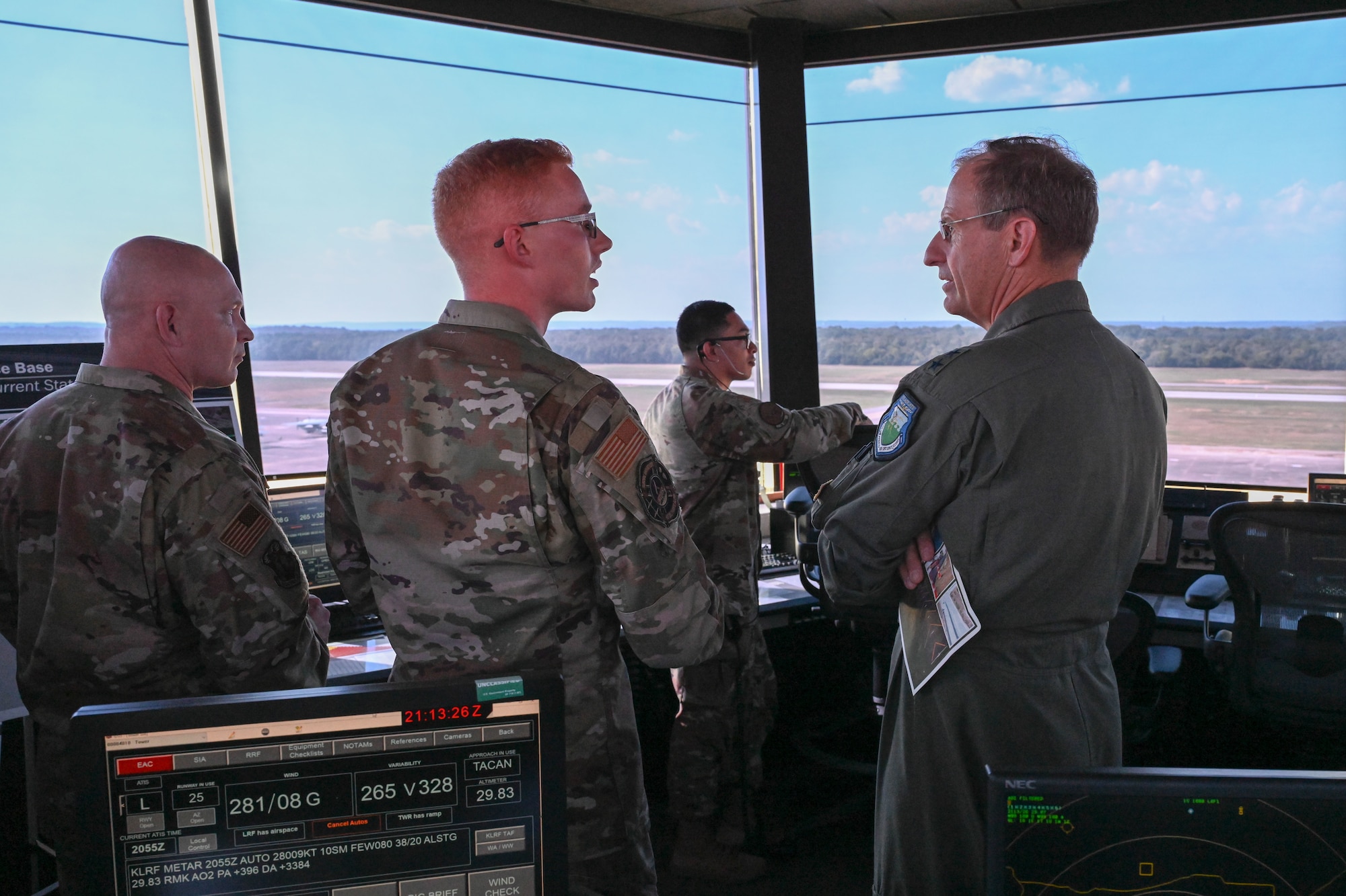 man in uniform speaks with commander at a visit to the air traffic control tower
