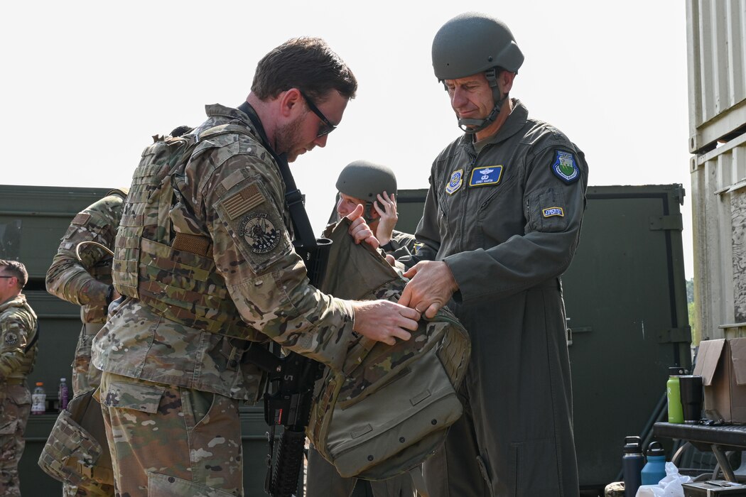 man in uniform puts on protective gear
