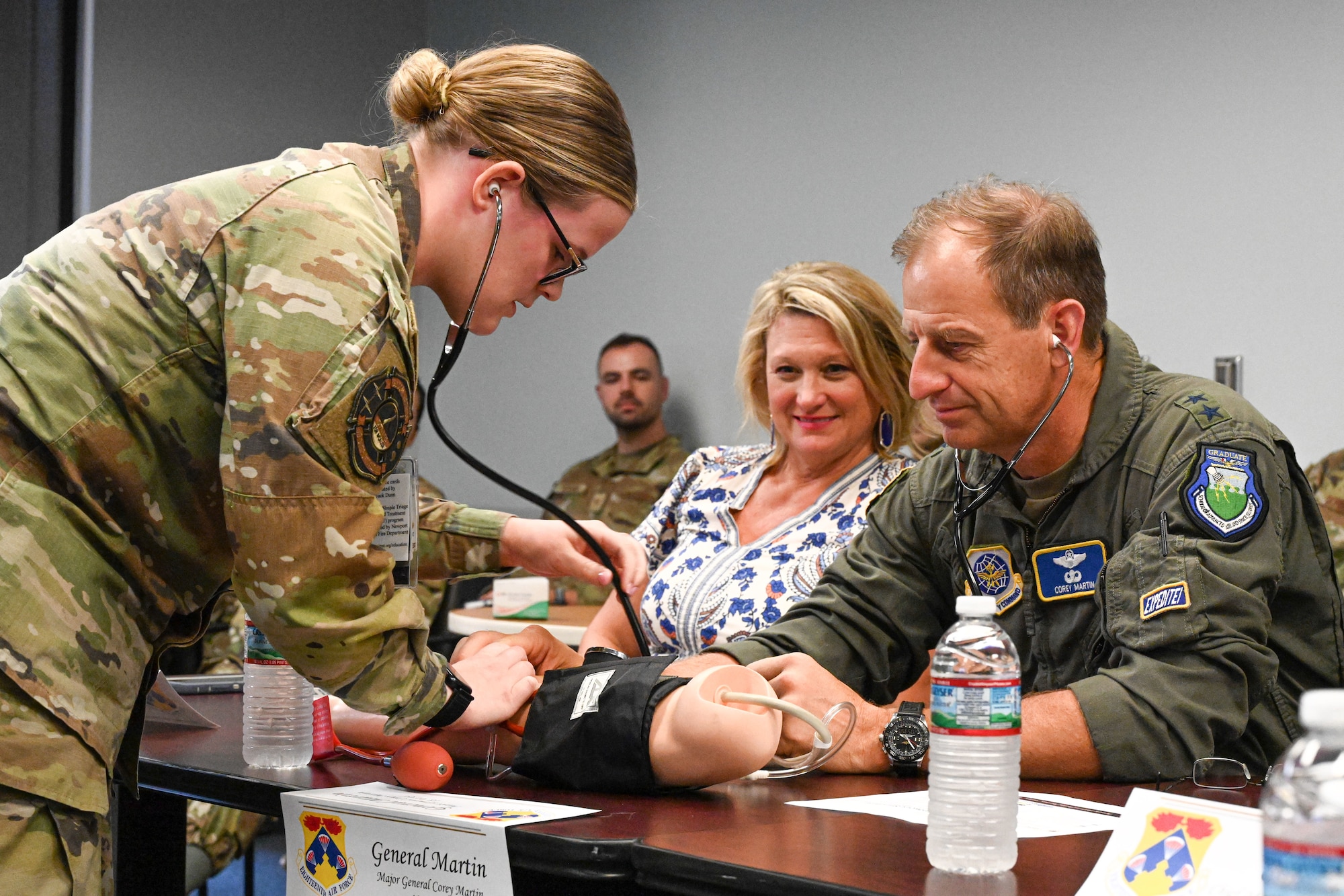 Airman helps commander check blood pressure