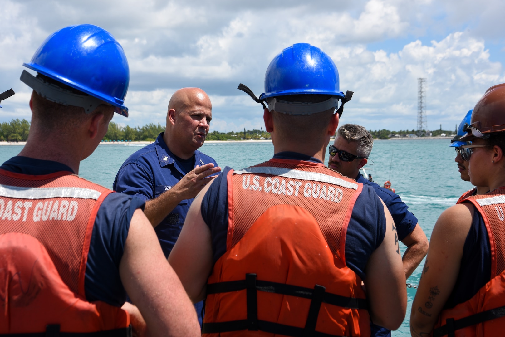 Master Chief Petty Officer Jeremy DeMello, the Coast Guard Atlantic Area command master chief, speaks with USCGC Mohawk (WMEC 913) crewmembers, Sept. 12, 2022, off the coast of Key West, Florida. DeMello embarked the Mohawk for their inbound transit to homeport after a 92-day AFRICOM deployment. (U.S. Coast guard photo by Petty Officer 3rd Class Jessica Fontenette)