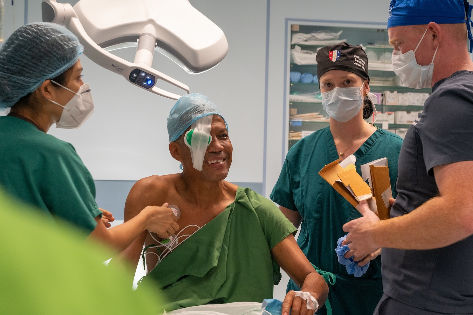 Two Ophthalmologists and a medical technician stand around a patient who received cataract surgery at Regional Hospital Dr. Luis "Chicho" Fabrega in Santiago de Veraguas, Panama, July 17, 2023.