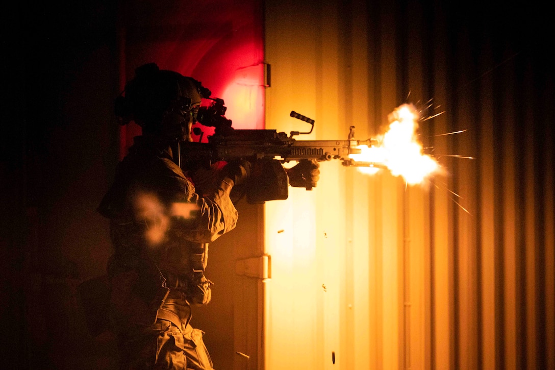 An airman fires a weapon.