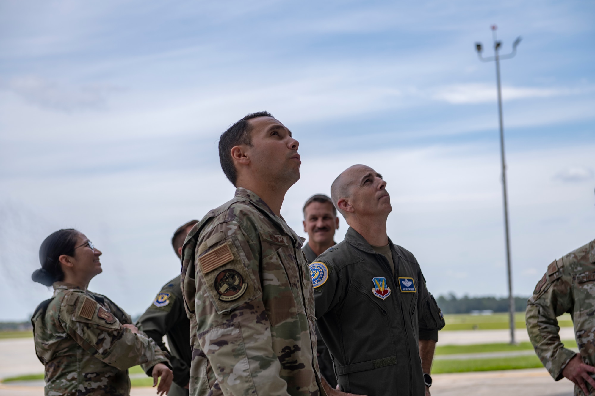 Two Airmen look inside a hanger to see damge done from a hurricane