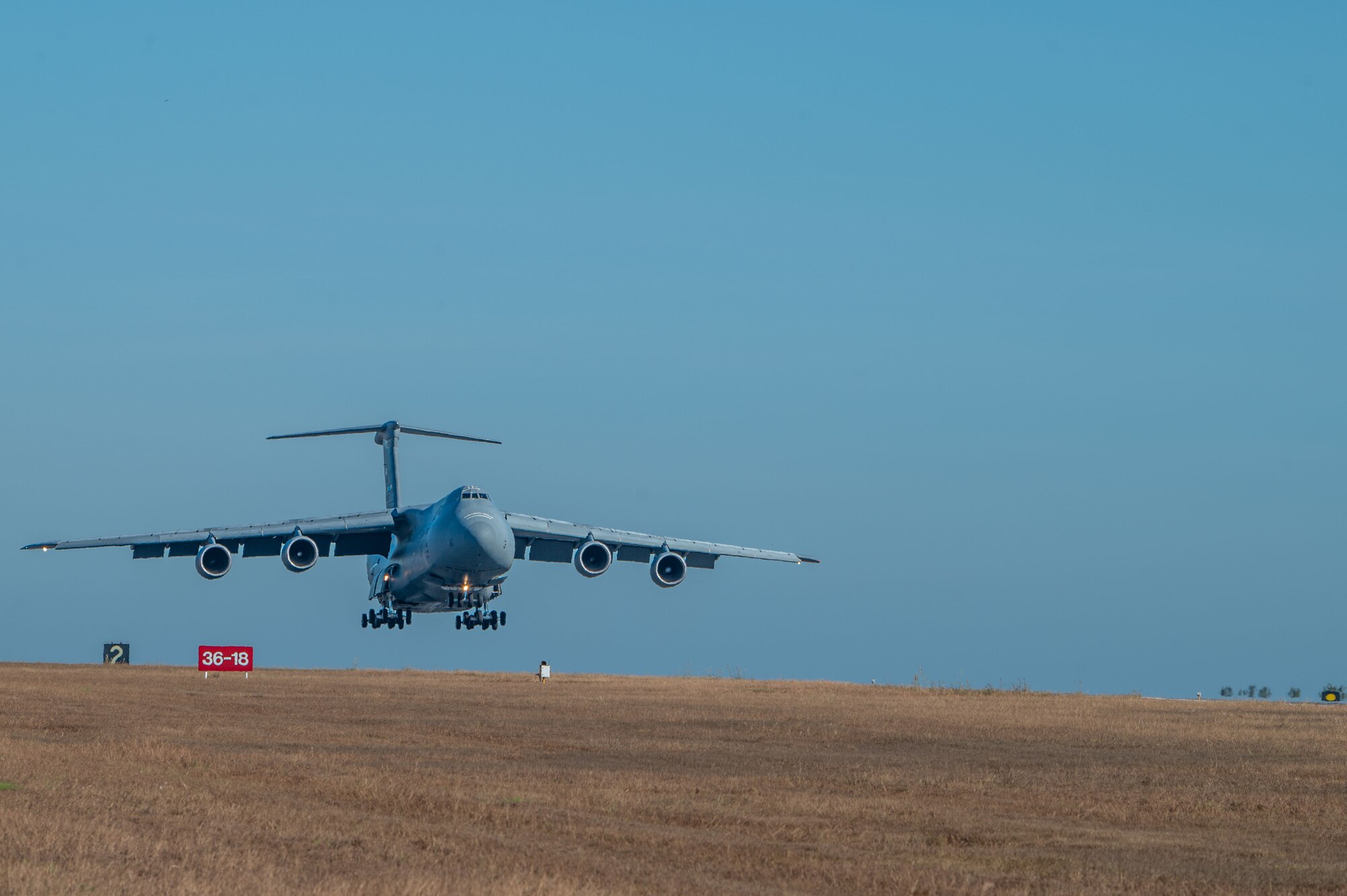 A U.S. Air Force C-5 Galaxy lands at Royal Australian Air Force Base Darwin, Australia, July 13, 2023. The C-5 was transporting two UH-1Y Venom helicopters in support of the Marine Rotational Force Darwin and Exercise Talisman Saber, which Exercise Mobility Guardian 23 personnel received and assisted in unloading. (U.S. Air Force photo by Airman 1st Class Stassney Davis)