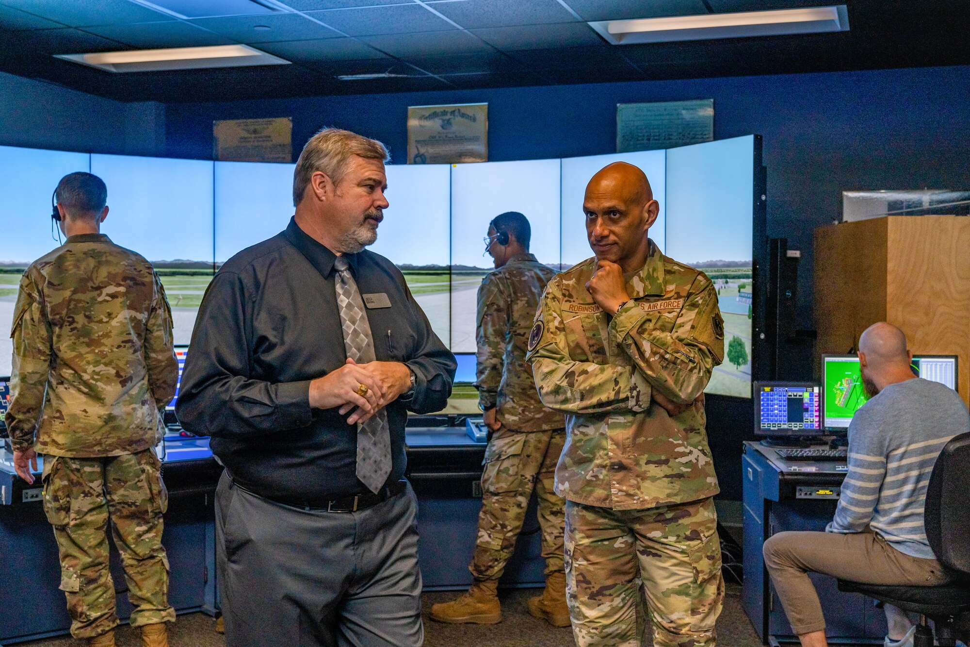 Mr. Robert Brown, 334th Training Squadron air traffic control flight chief, briefs U.S. Air Force Lt. Gen. Brian Robinson, commander of Air Education and Training Command commander, on the different simulators in use at Keesler Air Force Base
