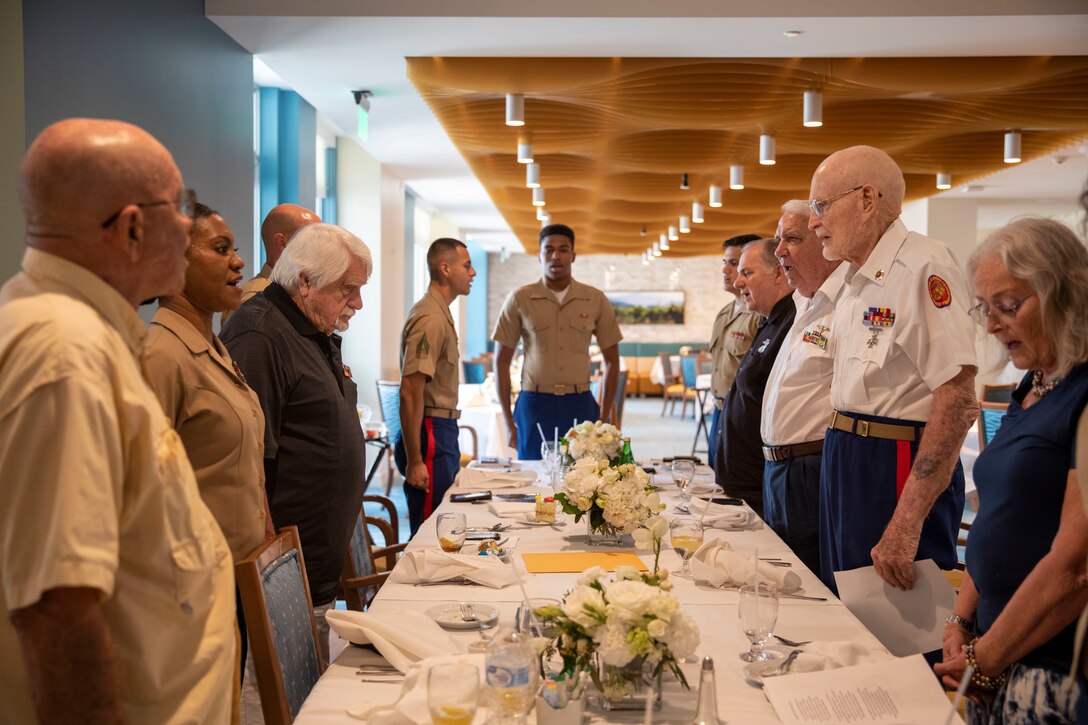 Iwo Jima veteran Marine Pfc. Robert Riechman recites the Marine Corps hymn alongside a group of past and current U.S. Marines at West Palm Gardens, Florida, Feb. 24, 2022. The Marines of 4th Civil Affairs Group visited Riechman for his upcoming birthday and the 77th anniversary of the Battle of Iwo Jima. (U.S Marine Corps photo by Sgt. Camila Melendez)