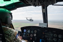 Capt. Cristopher Rocco, a 54th Helicopter Squadron (HS) UH-1N Iroquois pilot, flies a spouse orientation flight over the town of Minot, North Dakota, Sept. 9, 2023. Spouses received a first hand experience of the 54th HS mission during the orientation flight, including: airlift of emergency security forces, security and surveillance of off-base nuclear weapons convoys, and distinguished visitor airlift. (U.S. Air Force photo by Airman 1st Class Alexander Nottingham)