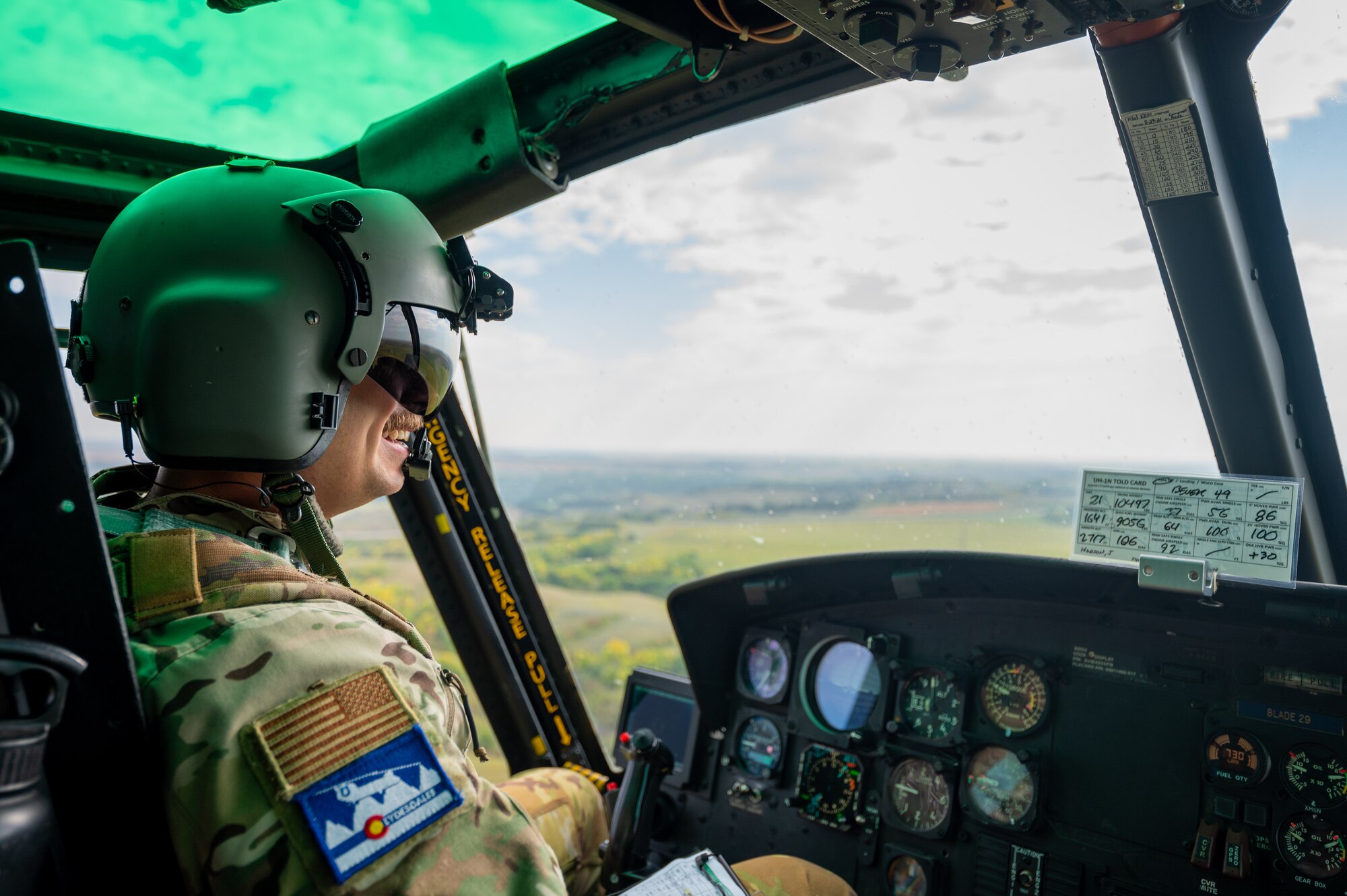 Capt. Cristopher Rocco, a 54th Helicopter Squadron (HS) UH-1N Iroquois pilot, flies a spouse orientation flight over the town of Minot, North Dakota, Sept. 9, 2023. Spouses received a first hand experience of the 54th HS mission during the orientation flight, including: airlift of emergency security forces, security and surveillance of off-base nuclear weapons convoys, and distinguished visitor airlift. (U.S. Air Force photo by Airman 1st Class Alexander Nottingham)