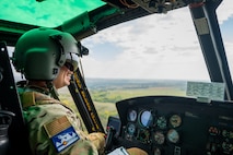 Capt. Cristopher Rocco, a 54th Helicopter Squadron (HS) UH-1N Iroquois pilot, flies a spouse orientation flight over the town of Minot, North Dakota, Sept. 9, 2023. Spouses received a first hand experience of the 54th HS mission during the orientation flight, including: airlift of emergency security forces, security and surveillance of off-base nuclear weapons convoys, and distinguished visitor airlift. (U.S. Air Force photo by Airman 1st Class Alexander Nottingham)