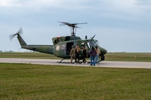 Aircrew with the 54th Helicopter Squadron (HS) load a UH-1N Iroquois ,“Huey”, with passengers for a spouse orientation flight at Minot Air Force Base, North Dakota, Sept. 9, 2023. During the orientation flight, the 54th HS provided spouses a first-hand experience of the mission and demonstrated how the unit conducts global deterrence missions. (U.S. Air Force photo by Airman 1st Class Alexander Nottingham)