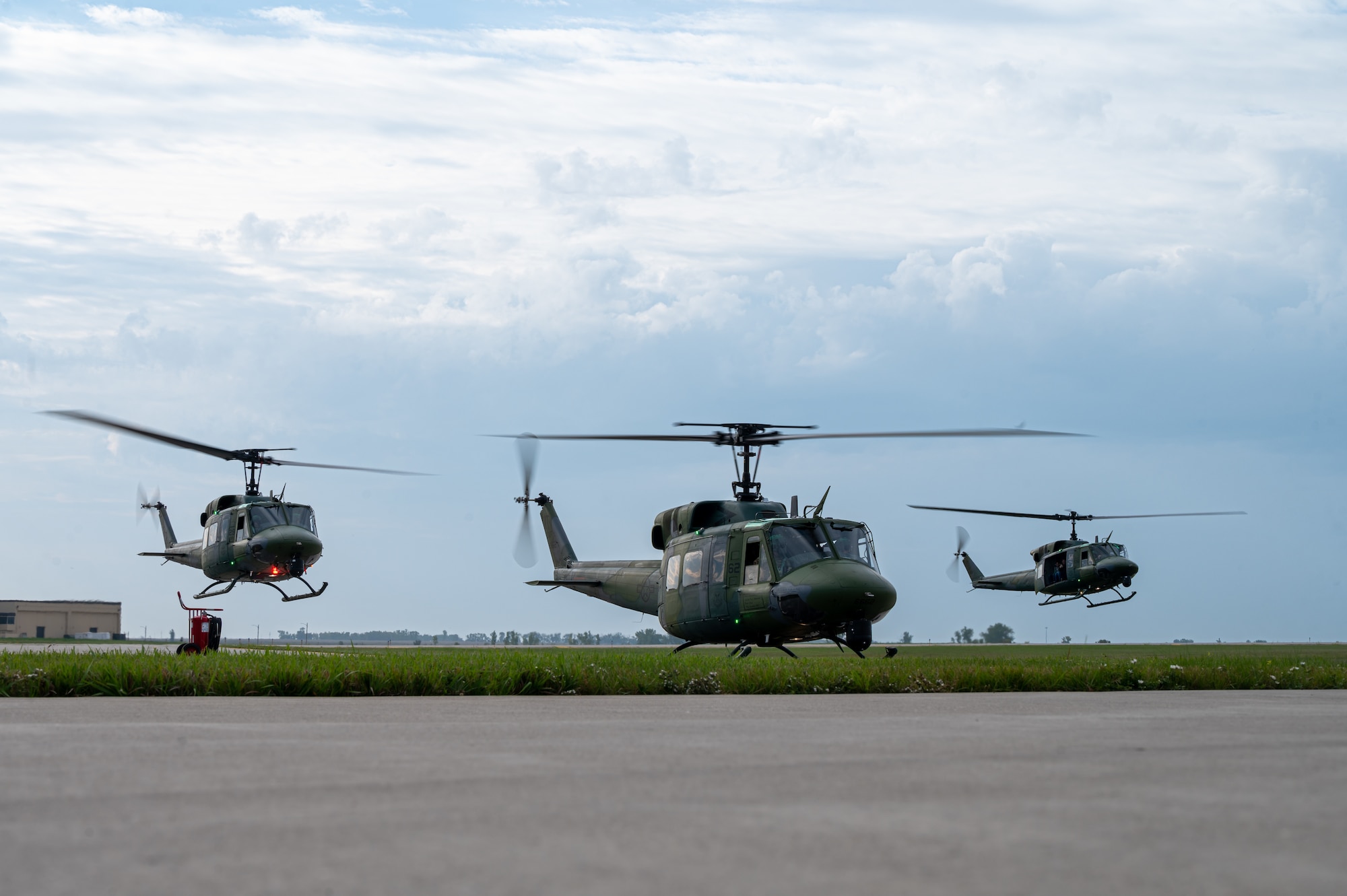 Three UH-1N Iroquois ,“Hueys”, assigned to the 54th Helicopter Squadron (HS) take off during a spouse orientation flight from Minot Air Force Base, North Dakota, Sept. 9, 2023. During the flight, Team Minot spouses received an aerial tour of MAFB’s area of responsibility. (U.S. Air Force photo by Airman 1st Class Alexander Nottingham)