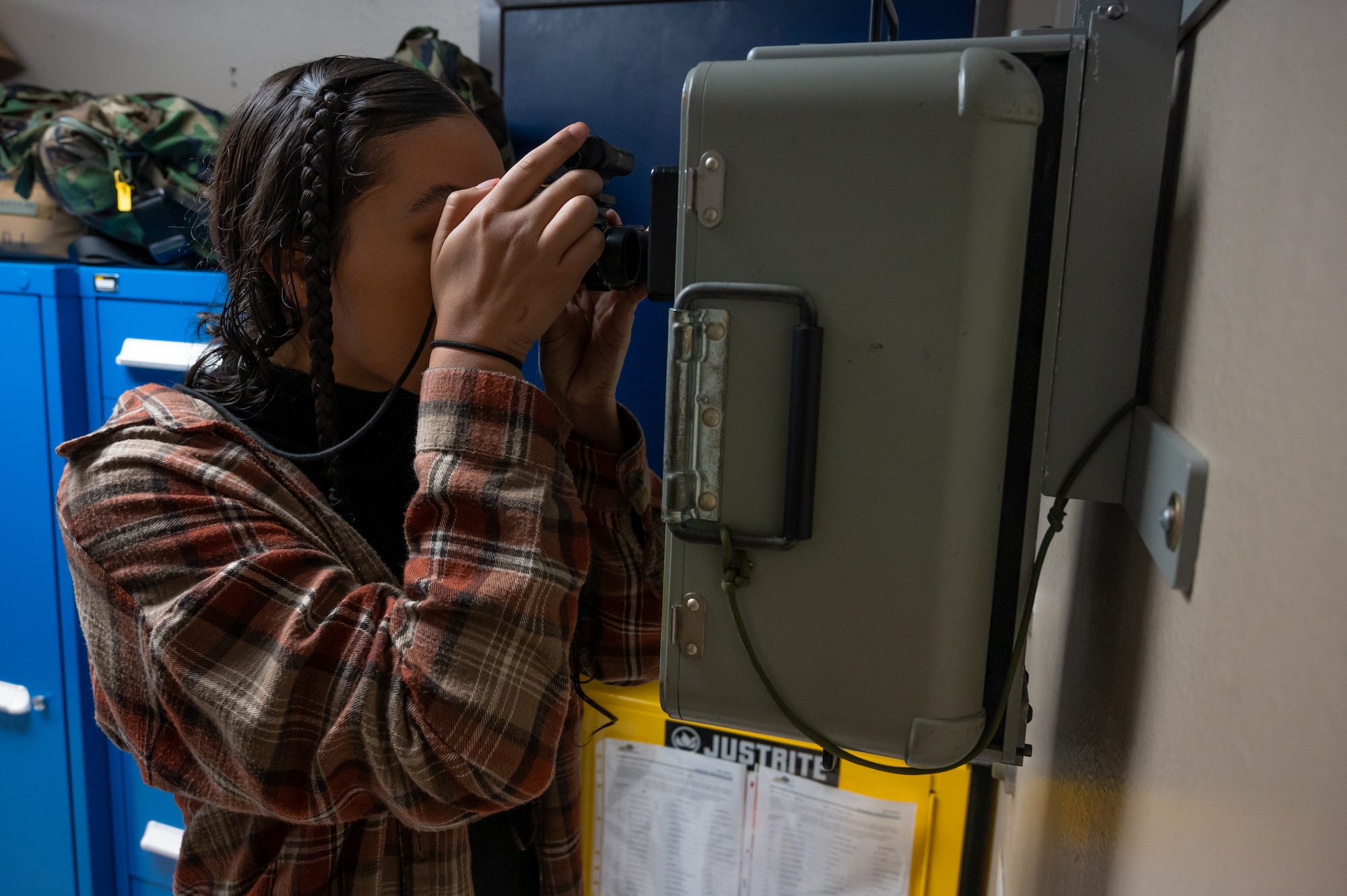 A Team Minot spouse tries on a pair of night vision goggles during a tour for spouses prior to a spouse orientation flight at Minot Air Force Base, North Dakota, Sept. 9, 2023. To learn more about the 54th Helicopter Squadron’s (HS) role on base, spouses had the opportunity to go hands-on with the tools used to complete its mission. (U.S. Air Force photo by Airman 1st Class Alexander Nottingham)