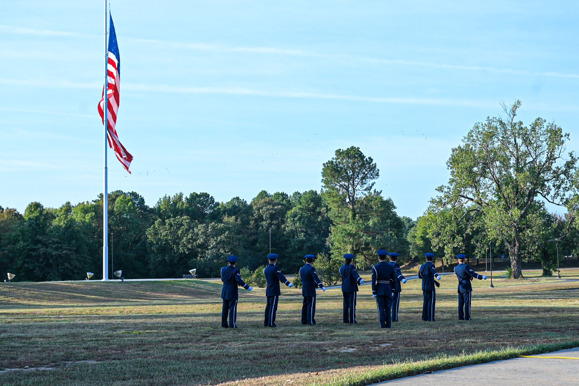 Airmen conduct a 21-gun salute.