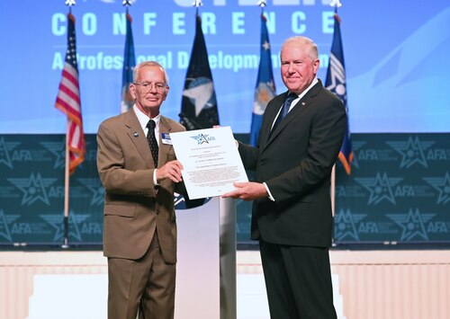 Secretary of the Air Force Frank Kendall receives the W. Stuart Symington Award from Air and Space Forces Association’s Chairman of the Board Bernie Skoch at the Air, Space and Cyber Conference in National Harbor, Md., Sept. 11, 2023. (U.S. Air Force photo by Andy Morataya)