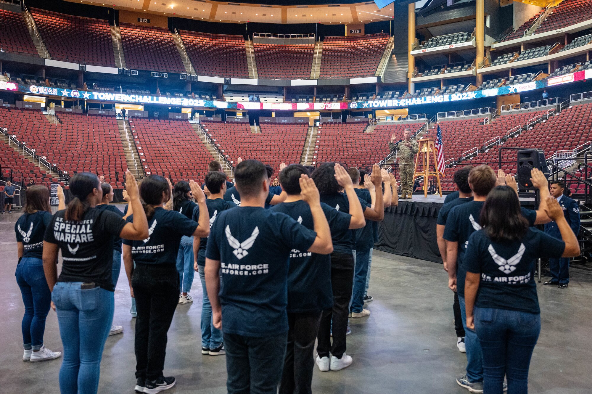 U.S. Air Force Col. Keagan McLeese, 56th Fighter Wing deputy commander, administers the Oath of Enlistment to U.S. Air Force recruits during the 9/11 Tower Challenge, Sept. 11, 2023, at Desert Diamond Arena, Glendale, Arizona.