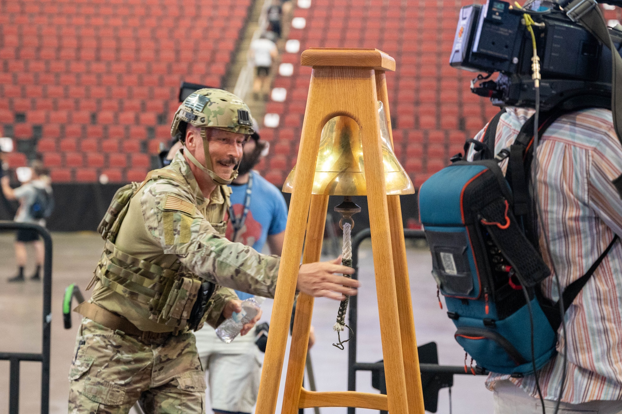 U.S. Air Force Chief Master Sgt. Brian Smith, 56th Operations Group senior enlisted leader, rings a bell after completing the 9/11 Tower Challenge, Sept. 11, 2023, at Desert Diamond Arena, Glendale, Arizona.