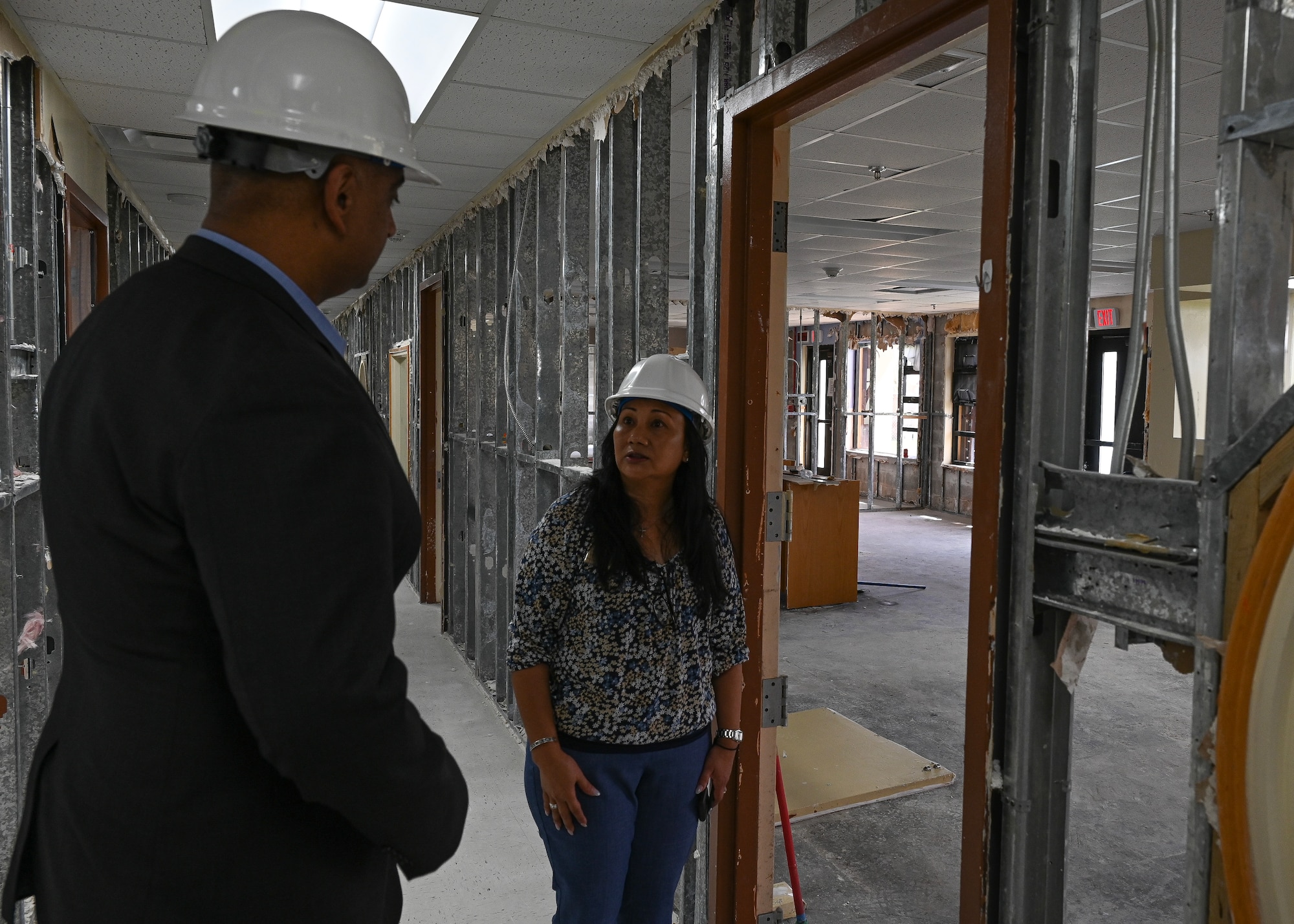 Dr. Ravy Chaudhary listens to Jeanette Rodriguez inside the partially damaged Child Development Center.