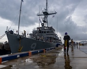 Dock workers at the Ishigaki Port assist U.S. Sailors with the Avenger-class Mine Countermeasure Ship 9 (MCM-9), USS Pioneer, after the ship pulled into port on Ishigaki Island, Okinawa, Japan, Sept. 7, 2023.