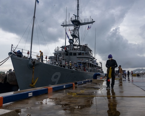 Dock workers at the Ishigaki Port assist U.S. Sailors with the Avenger-class Mine Countermeasure Ship 9 (MCM-9), USS Pioneer, after the ship pulled into port on Ishigaki Island, Okinawa, Japan, Sept. 7, 2023.