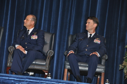 two people listen to a person speak
