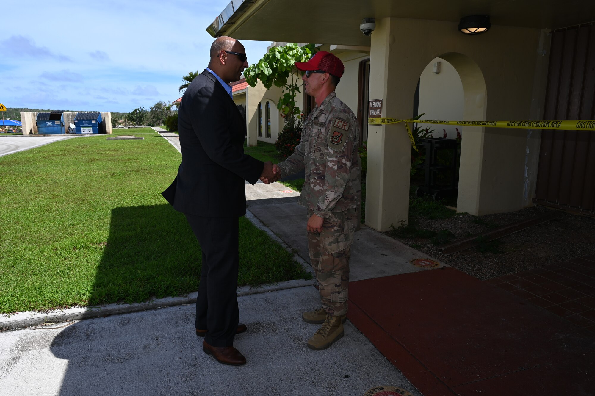 Dr. Ravi Chaudhary shakes hands and coins an Airman.