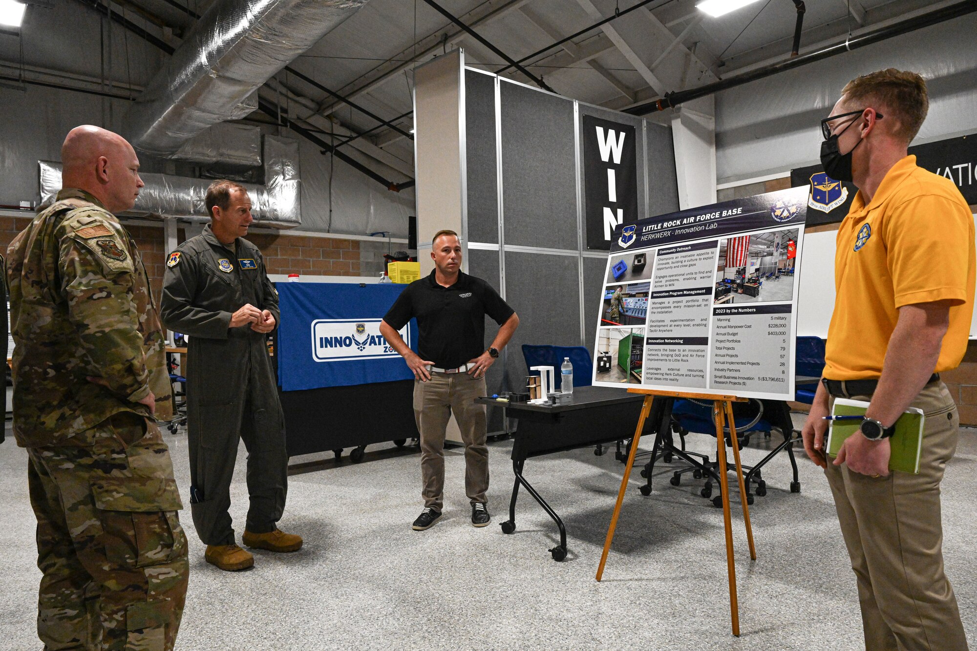 men in uniform receive a brief from HERKWERX.
