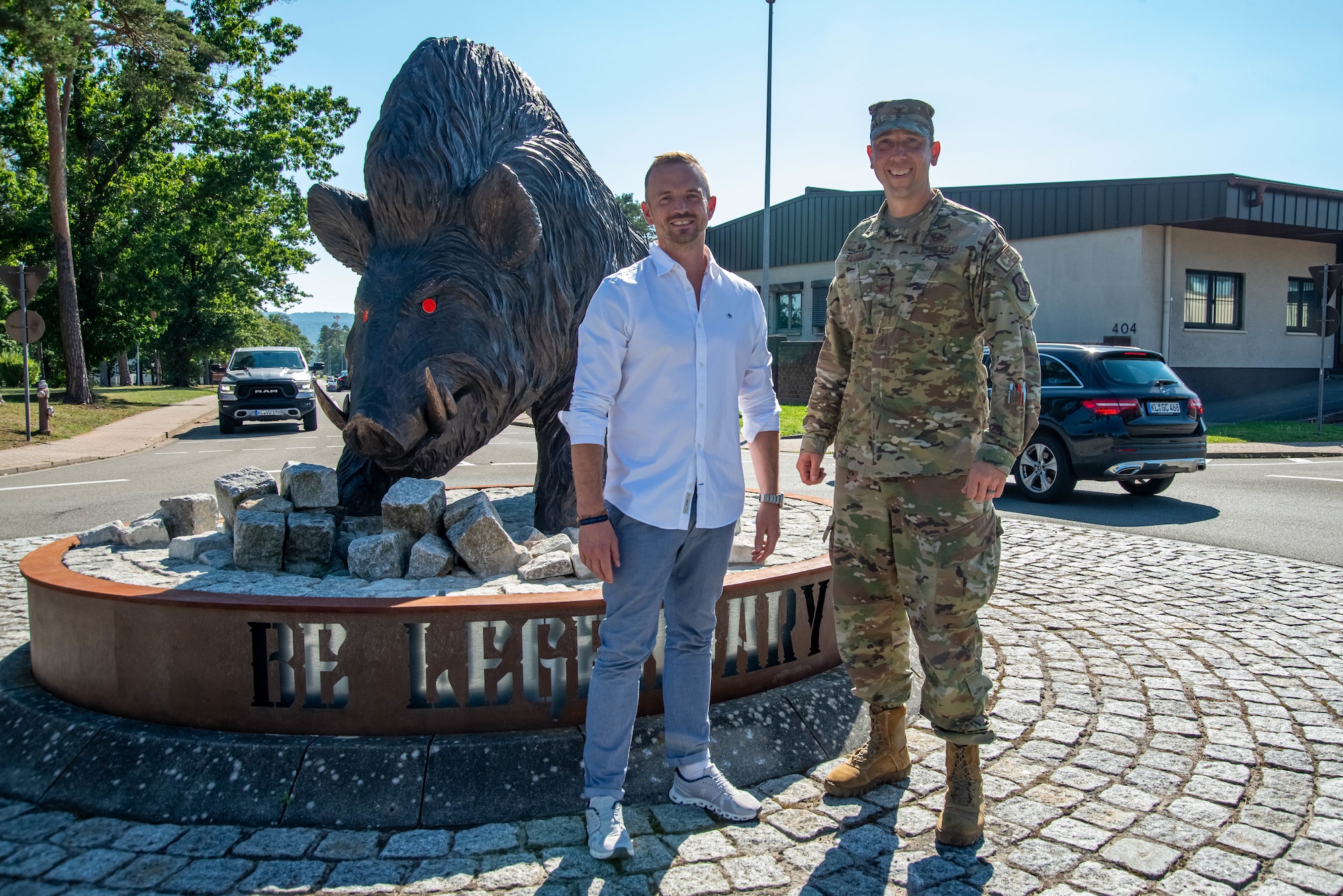 86th Civil Engineer Group honorary commander and commander stand by a bar statue