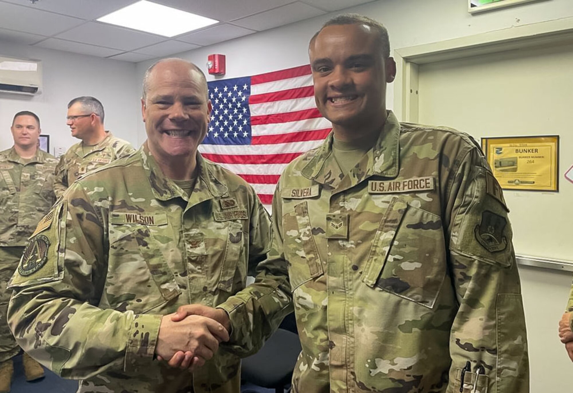 A photo of two Airmen shaking hands.