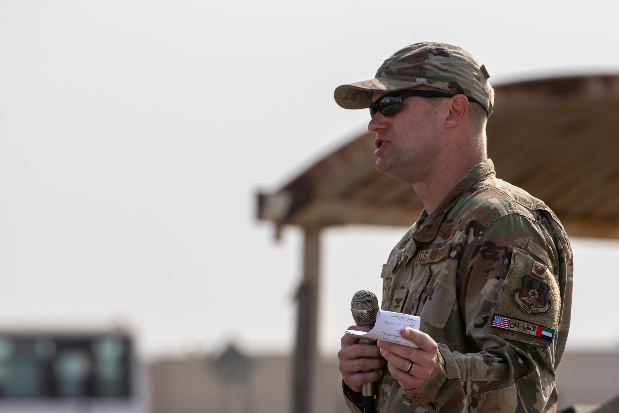 A photo of an Airman speaking to a crowd.