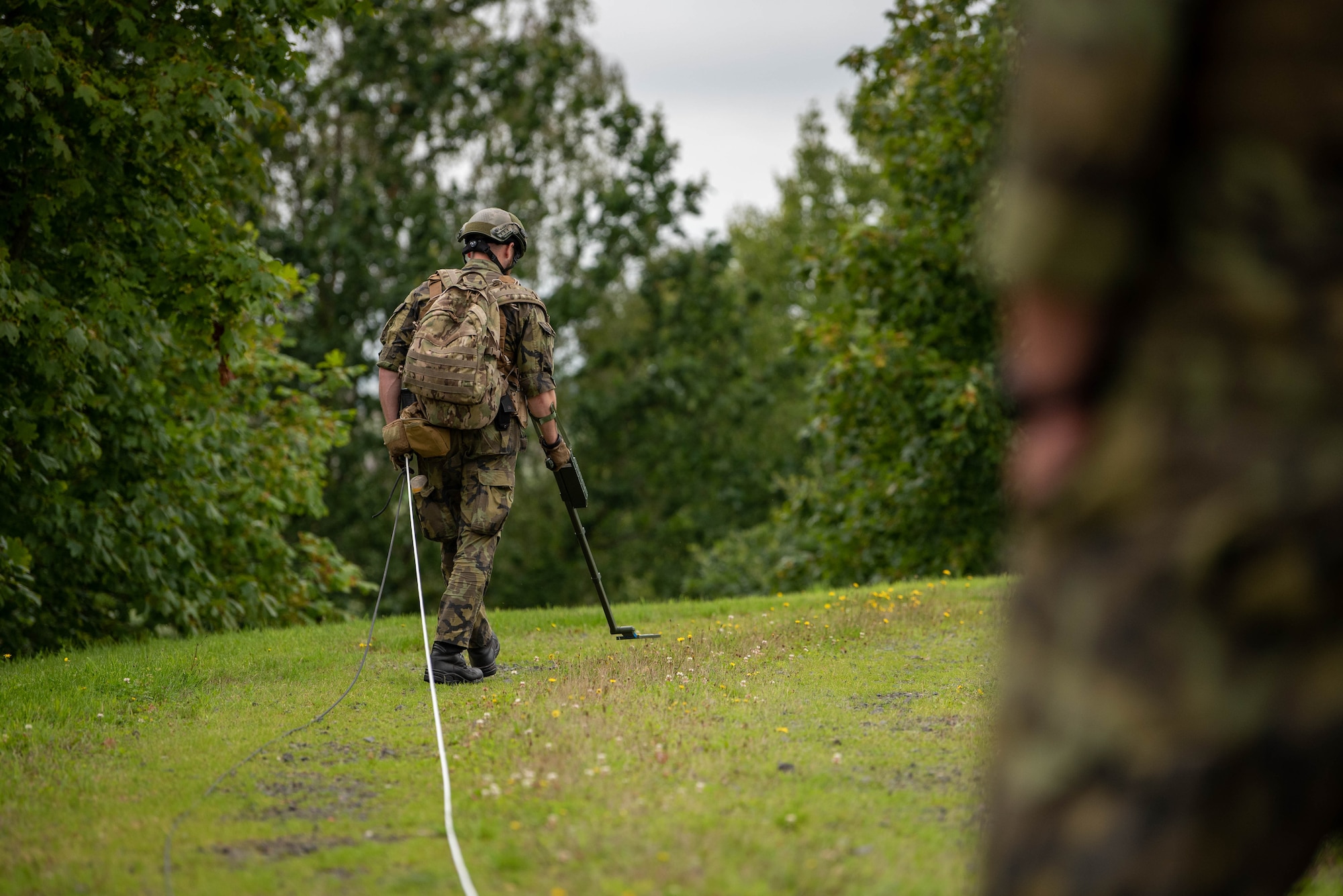 A Czech Republic Explosive Ordnance Disposal team member searches an area for simulated Improvised Explosive Devices (IED) during an annual IED Rodeo exercise at Spangdahlem Air Base, Germany, Aug.14, 2023.