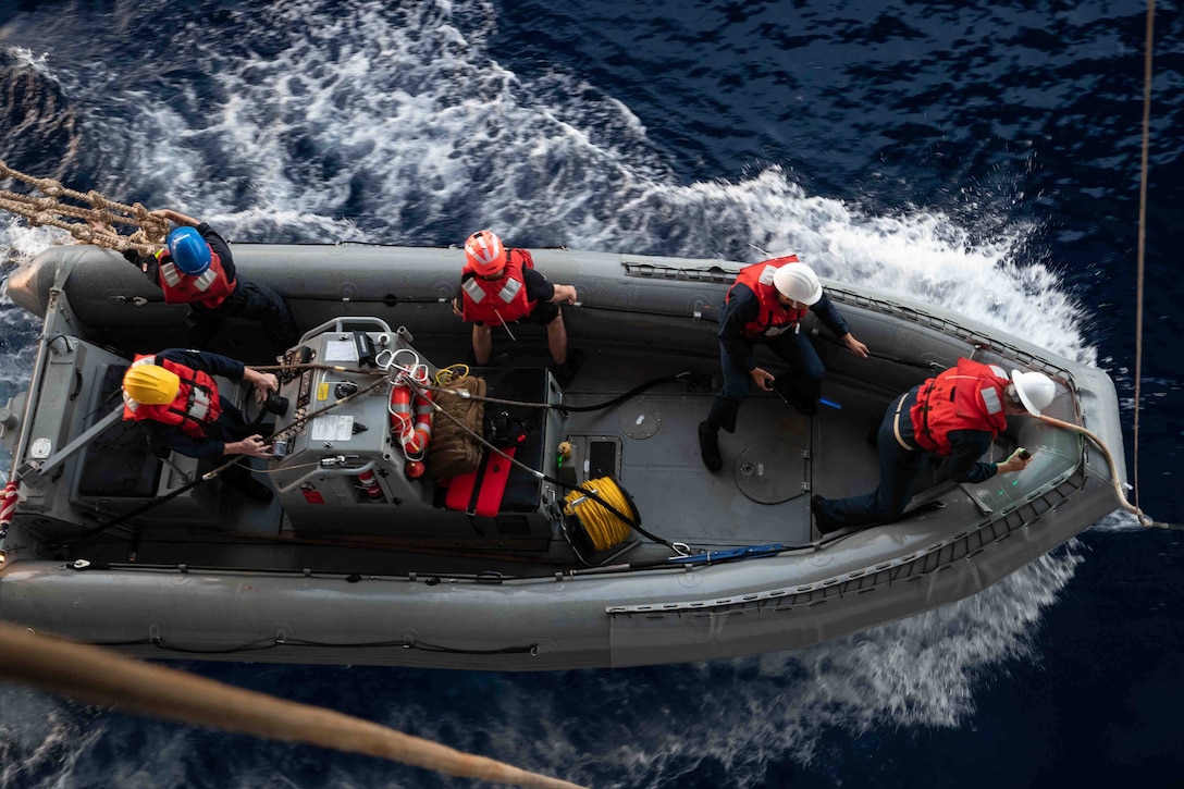 Sailors in a rigid-hull inflatable boat conduct small-boat operations.