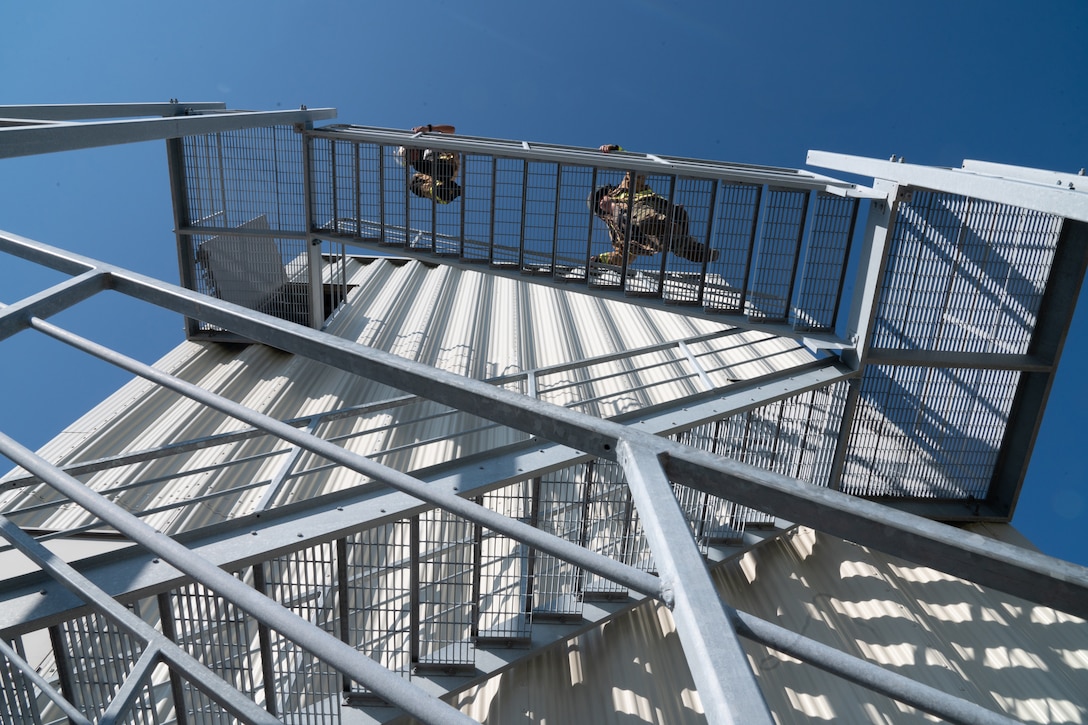 Airmen climb stairs.