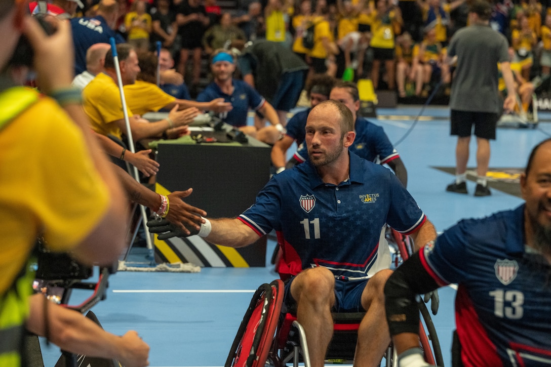Athletes shake hands after a wheelchair rugby match.